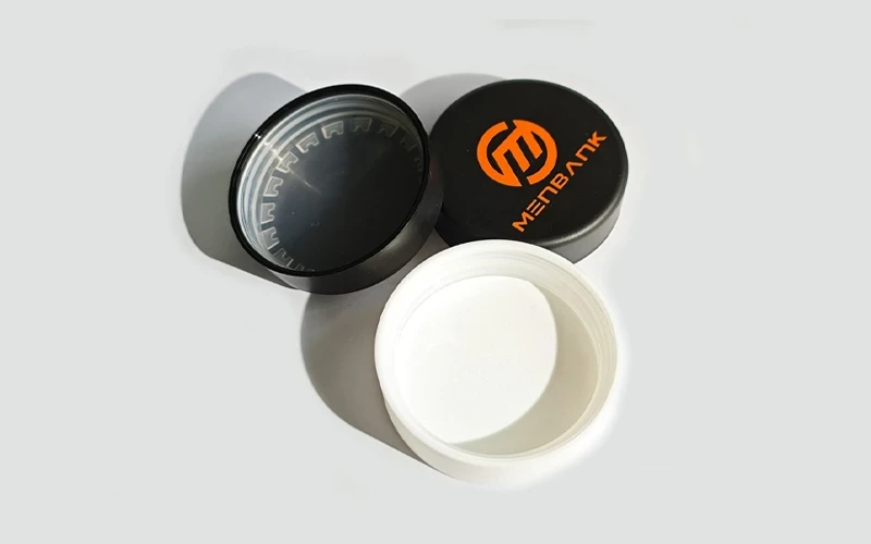 Close-up of child-resistant cannabis packaging using a push-and-turn cap on a glass jar.